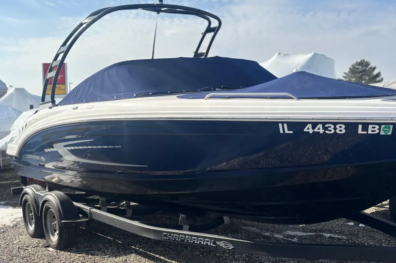 Slide: The Image of 2021 Chaparral 23 SSi boat on trailer, blue cover, parked outdoors. - 5