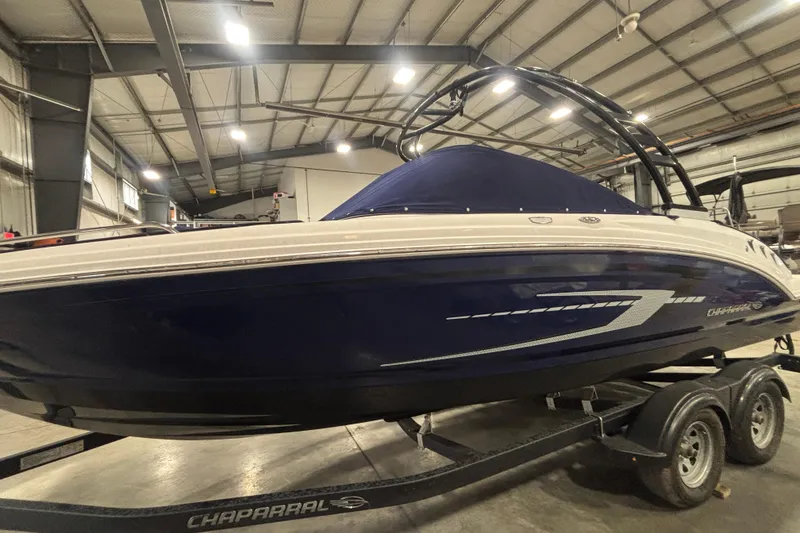 Slide: The Image of 2021 Chaparral 23 SSi boat in indoor storage, blue hull, on trailer. - 7
