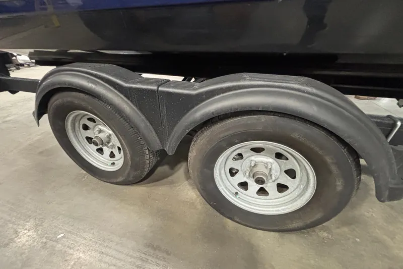 Slide: The Image of Trailer wheels of a 2021 Chaparral 23 SSi boat on a concrete surface. - 8