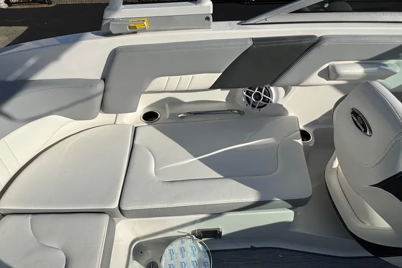 Slide: The Image of Interior seating of 2022 Chaparral 23 SSi OB boat, featuring white and gray upholstery. - 10