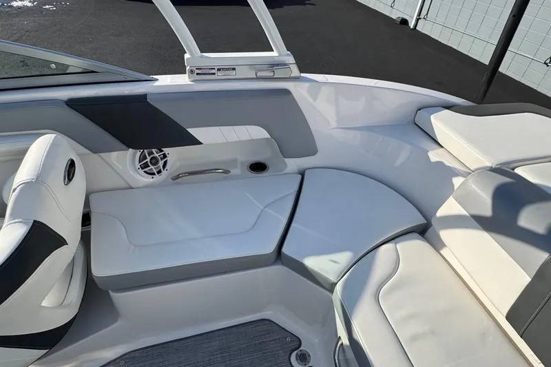 Slide: The Image of 2022 Chaparral 23 SSi OB boat interior with white seating and speaker. - 13