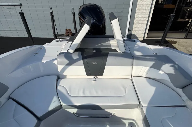 Slide: The Image of 2022 Chaparral 23 SSi OB boat interior with white and gray seating. - 14
