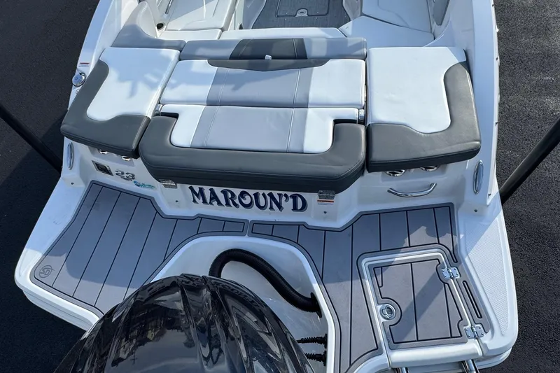 Slide: The Image of 2022 Chaparral 23 SSi OB boat with cushioned seating and sleek design. - 16