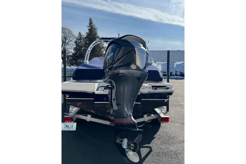 Slide: The Image of 2022 Chaparral 23 SSi OB boat with Yamaha outboard motor, parked on a trailer. - 17
