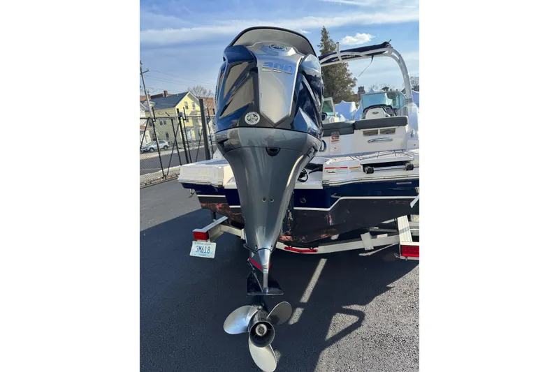 Slide: The Image of 2022 Chaparral 23 SSi OB boat with powerful outboard motor, parked on a trailer. - 18