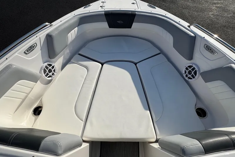 Slide: The Image of 2022 Chaparral 23 SSi OB boat interior with cushioned seating and speakers. - 2