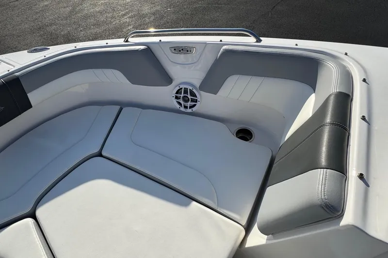 Slide: The Image of 2022 Chaparral 23 SSi OB boat interior with cushioned seating and speaker. - 3