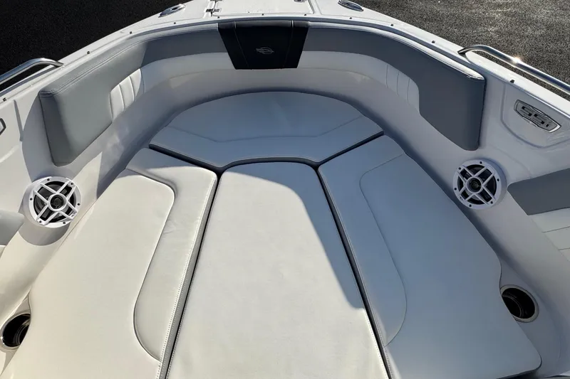 Slide: The Image of 2022 Chaparral 23 SSi OB boat interior with cushioned seating and built-in speakers. - 4