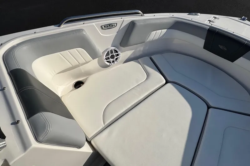 Slide: The Image of 2022 Chaparral 23 SSi OB boat interior with cushioned seating and speaker. - 5