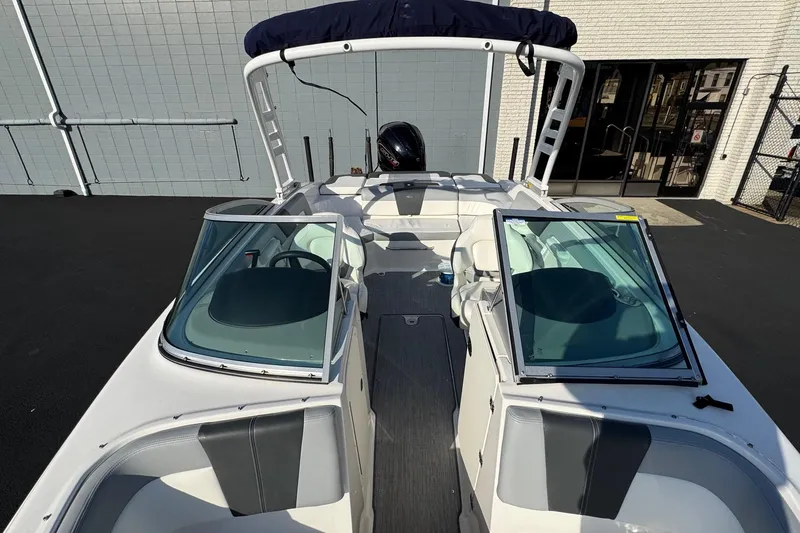 Slide: The Image of 2022 Chaparral 23 SSi OB boat with open cockpit and sleek design. - 6