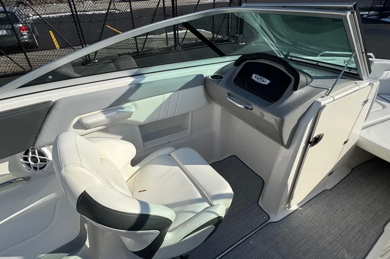 Slide: The Image of 2022 Chaparral 23 SSi OB boat interior with white seating and dashboard. - 9