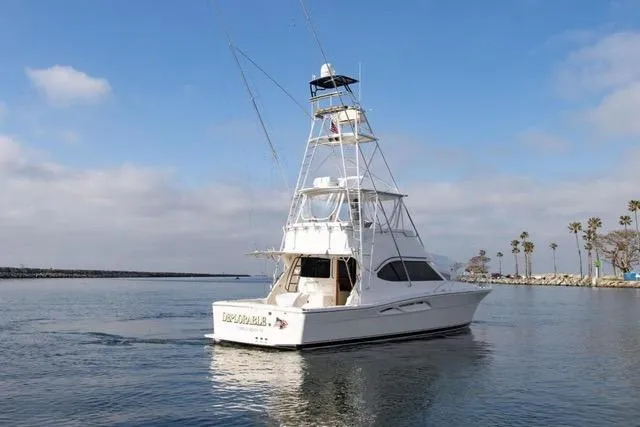 Slide: The Image of 2003 Riviera 4700 Sport Yacht cruising on calm waters under a clear sky. - 10