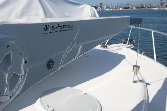 Slide: The Image of 2003 Riviera 4700 Sport Yacht deck with Nick Jackson equipment, docked by the water. - 17