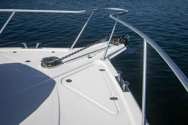 Slide: The Image of Bow of 2003 Riviera 4700 Sport Yacht with anchor chain over calm water. - 20