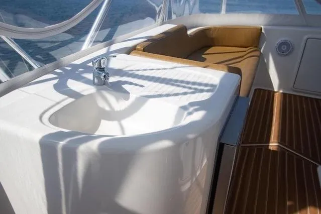 Slide: The Image of 2003 Riviera 4700 Sport Yacht interior with sink and seating area. - 23