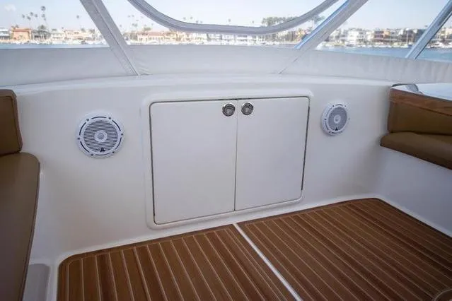 Slide: The Image of Interior of 2003 Riviera 4700 Sport Yacht with wood flooring and built-in speakers. - 26