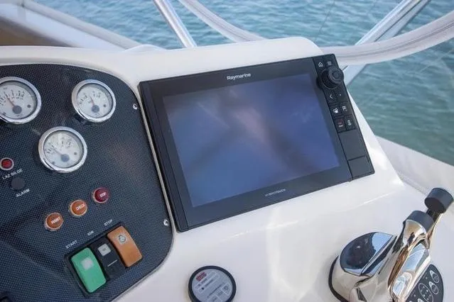 Slide: The Image of Control panel of 2003 Riviera 4700 Sport Yacht with navigation display and gauges. - 28