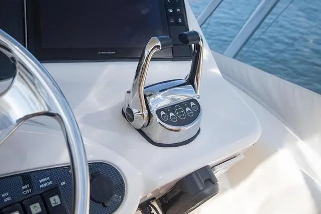 Slide: The Image of Control panel of a 2003 Riviera 4700 Sport Yacht with throttle levers and navigation display. - 29