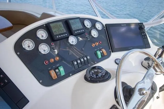 Slide: The Image of Dashboard of 2003 Riviera 4700 Sport Yacht with gauges and navigation equipment. - 31