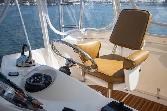 Slide: The Image of Helm of 2003 Riviera 4700 Sport Yacht with leather seat and steering wheel. - 35