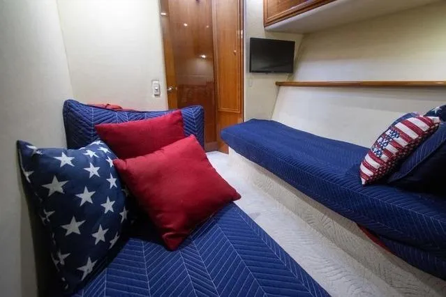 Slide: The Image of Interior of 2003 Riviera 4700 Sport Yacht with blue and red star-themed cushions. - 38