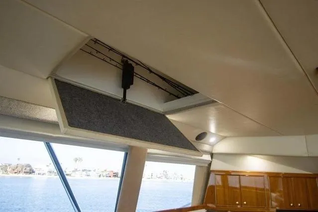 Slide: The Image of Interior view of 2003 Riviera 4700 Sport Yacht with open ceiling panel. - 56