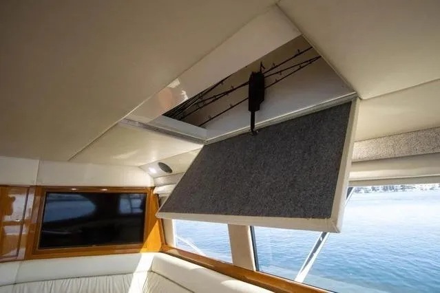 Slide: The Image of Interior of 2003 Riviera 4700 Sport Yacht with open sunroof and water view. - 57