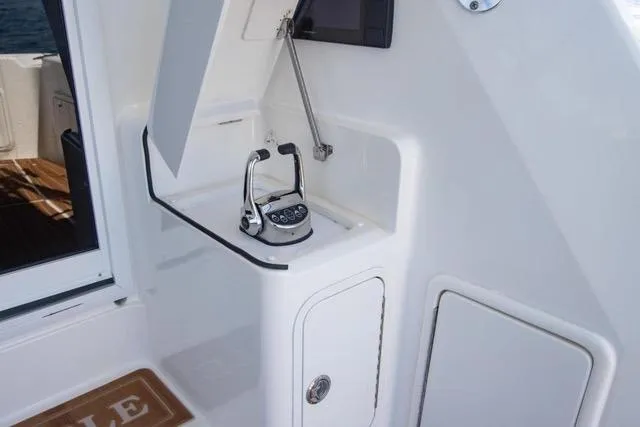 Slide: The Image of 2003 Riviera 4700 Sport Yacht control panel with sleek white design and modern features. - 15