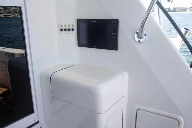 Slide: The Image of 2003 Riviera 4700 Sport Yacht interior with navigation panel and seating. - 16