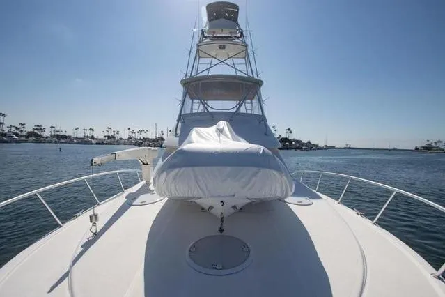 Slide: The Image of 2003 Riviera 4700 Sport Yacht on water, front view with clear sky. - 21