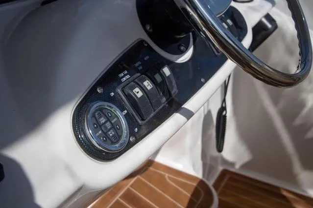 Slide: The Image of Control panel of 2003 Riviera 4700 Sport Yacht with steering wheel and switches. - 30