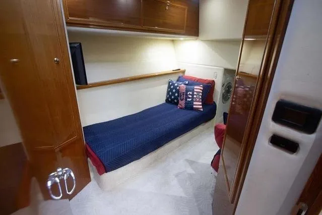 Slide: The Image of Cozy cabin interior of 2003 Riviera 4700 Sport Yacht with single bed and decorative pillows. - 41