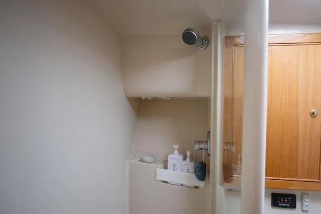 Slide: The Image of Bathroom interior of 2003 Riviera 4700 Sport Yacht with shower and wooden cabinet. - 42