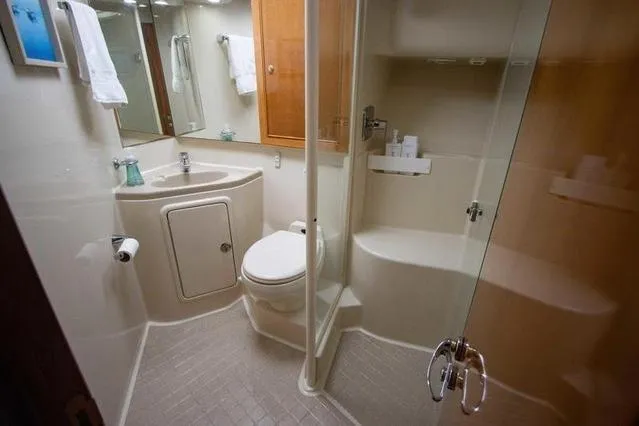 Slide: The Image of Luxurious bathroom in 2003 Riviera 4700 Sport Yacht with modern amenities and elegant design. - 44