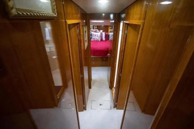 Slide: The Image of Interior hallway of 2003 Riviera 4700 Sport Yacht with wooden paneling and carpeted floor. - 51