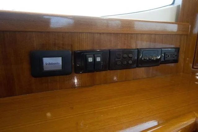 Slide: The Image of Control panel on 2003 Riviera 4700 Sport Yacht with wood finish. - 58