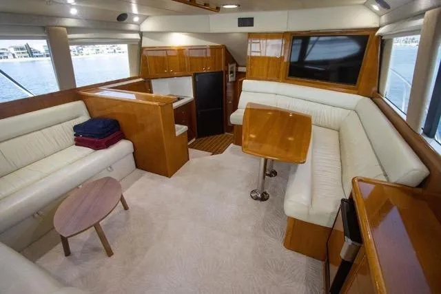 Slide: The Image of Luxurious interior of 2003 Riviera 4700 Sport Yacht with elegant wood and leather furnishings. - 6