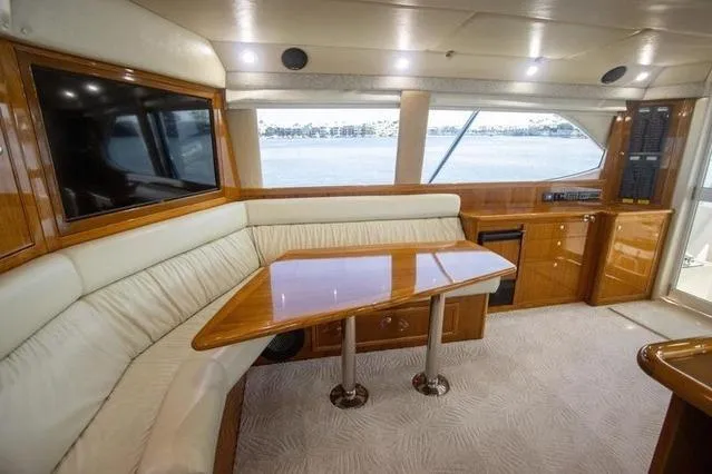 Slide: The Image of Luxurious interior of 2003 Riviera 4700 Sport Yacht with elegant seating and wooden table. - 63
