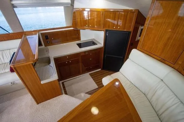 Slide: The Image of Luxurious interior of 2003 Riviera 4700 Sport Yacht with wood finish and modern amenities. - 64