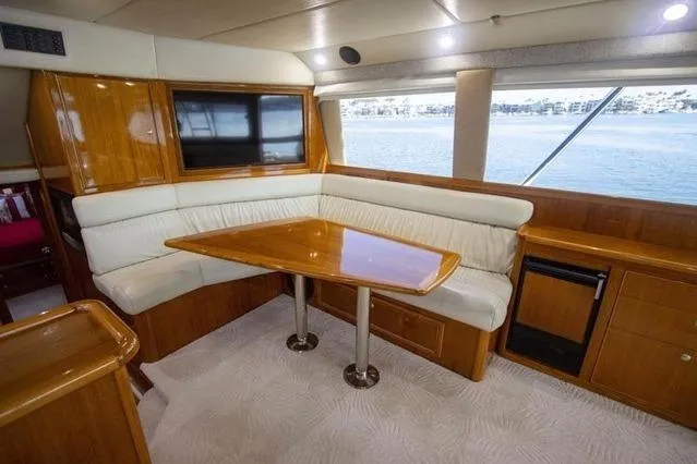 Slide: The Image of Interior of 2003 Riviera 4700 Sport Yacht with elegant wood and leather seating. - 66