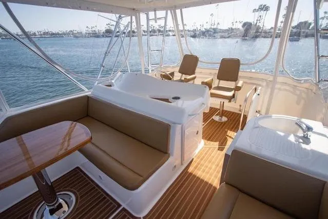 Slide: The Image of Luxurious 2003 Riviera 4700 Sport Yacht interior with seating and ocean view. - 67