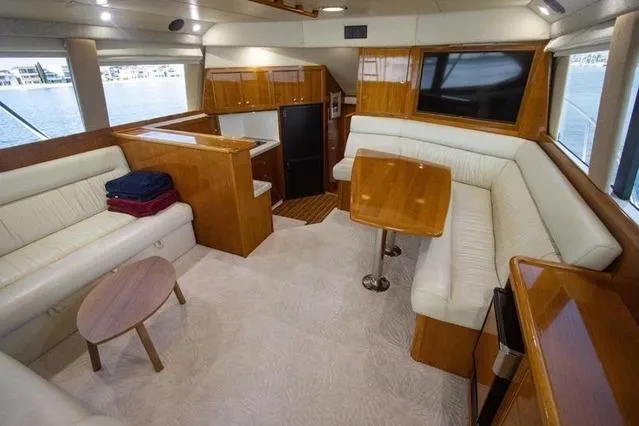 Slide: The Image of Luxurious interior of 2003 Riviera 4700 Sport Yacht with elegant wood finishes and plush seating. - 70