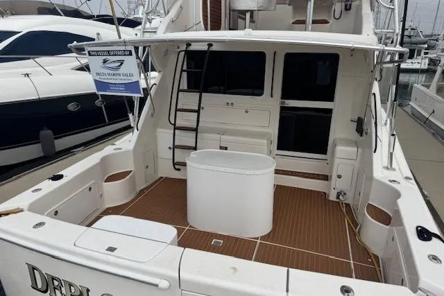 Slide: The Image of 2003 Riviera 4700 Sport Yacht with spacious deck and modern amenities at marina. - 72