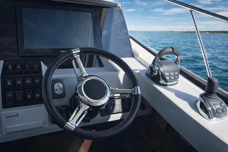 Slide: The Image of Steering console of 2019 Regal 42 Grande Coupe yacht on open water. - 10