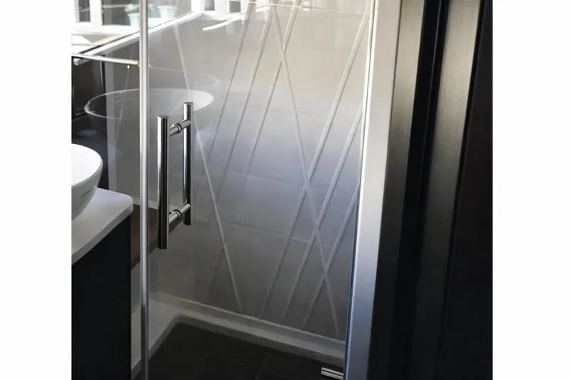 Slide: The Image of Shower area in 2019 Regal 42 Grande Coupe with modern glass door and sleek handle. - 18