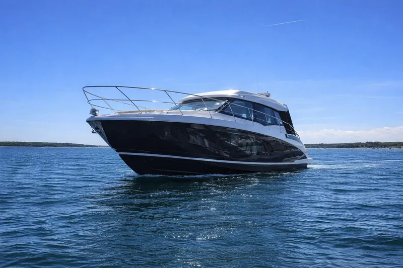 Slide: The Image of 2019 Regal 42 Grande Coupe yacht cruising on open water under clear blue skies. - 3