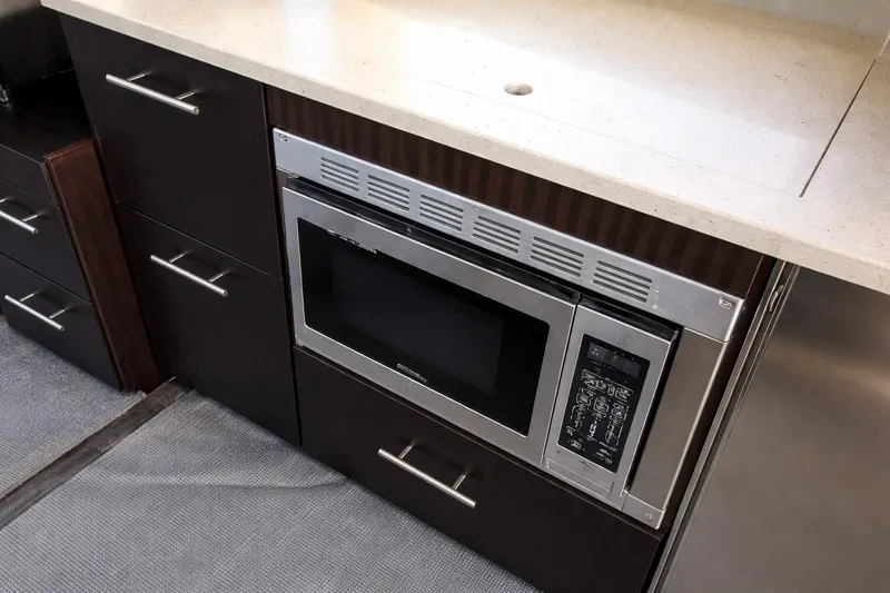 Slide: The Image of Modern kitchen area in 2019 Regal 42 Grande Coupe yacht with built-in microwave. - 9