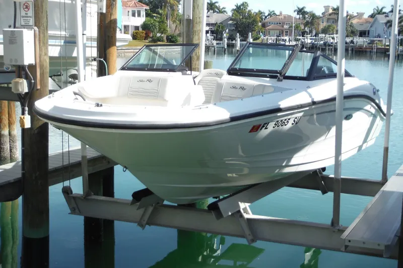 Slide: The Image of 2021 Sea Ray SPX 190 Outboard boat docked in a marina setting. - 11
