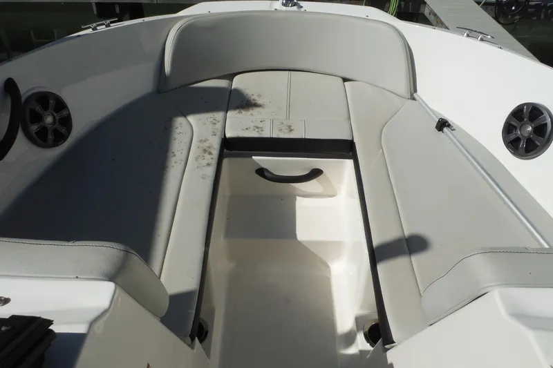 Slide: The Image of 2021 Sea Ray SPX 190 Outboard boat interior with white seating and speakers. - 17