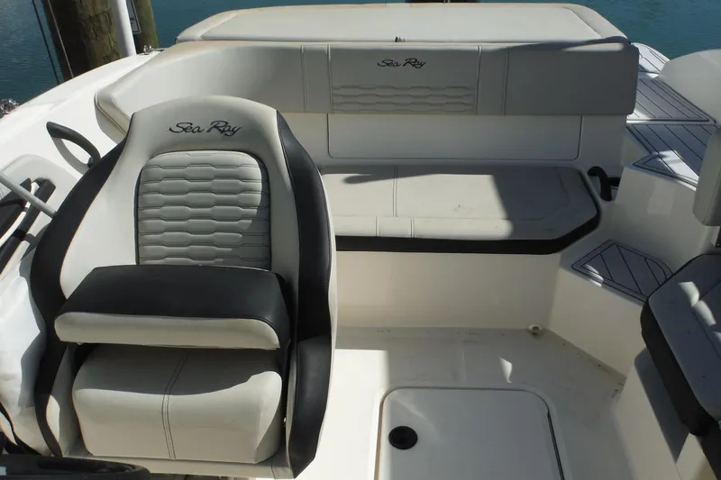 Slide: The Image of 2021 Sea Ray SPX 190 Outboard boat interior with cushioned seating and steering wheel. - 23
